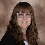 portrait headshot against a brown background of Carmen Woiak, Assistant Branch Manager in Abbotsford