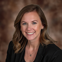 headshot of Brittany Helf, Commercial Loan Officer for AbbyBank in Green Bay on brown background