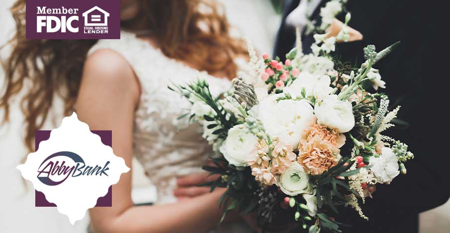 close-up of bride and groom in wedding attire with a bouquet of flowers