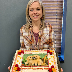 Mandi posing with cake for her 20th anniversary